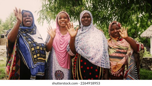 A Group of Authentic African Women in Traditional Clothes Waving and Smiling at the Camera. Friendly Female Rural Villagers Welcoming People in their Village with Big Smiles and Open Hearts - Shutterstock ID 2264918953