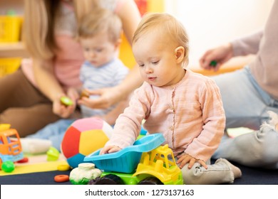 Group Of Babies With Mothers Playing Toys At Playgroup