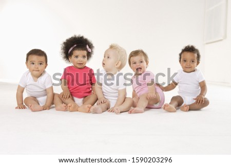 Group of babies sitting on floor
