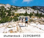 A group of backpackers hiking the John Muir Trail in the Sierra Nevada Mountains of California