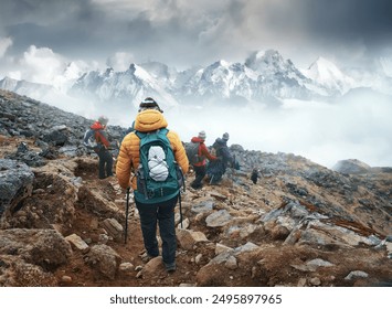 Group of backpackers walking down a mountain trail with Himalayan mountains in the background during a trek in Langtang National Park, Nepal.
Beautiful inspirational landscape, trekking and activity.
 - Powered by Shutterstock