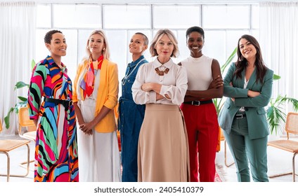 Group of beautiful confident businesswomen meeting in the office - Multiethinc female creative team brainstorming at work - Diverse colleagues working together  in workshop  in a co-working space - Powered by Shutterstock