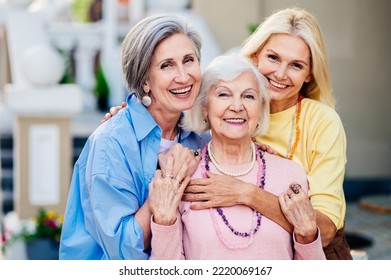 Group of beautiful and happy senior adult women dating outdoors and meeting in the city - Stylish fashionable old mature people social gathering and having fun in a cafe - Powered by Shutterstock