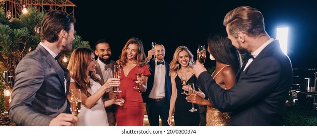 Group Of Beautiful People In Formalwear Communicating And Smiling While Spending Time On Luxury Party