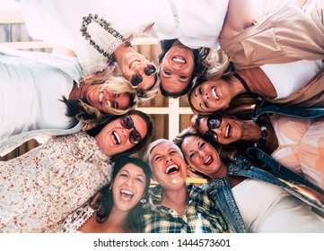 Group Of Beautiful People In Friendship Enjoying The Party Outside On The Terrace. Large Smiles For The Photo From Below. Nine Women Together