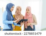 Group of a beautiful smart Asian muslim woman standing in the room and having a discussion together. Modern muslim society concept, women muslim student talking.