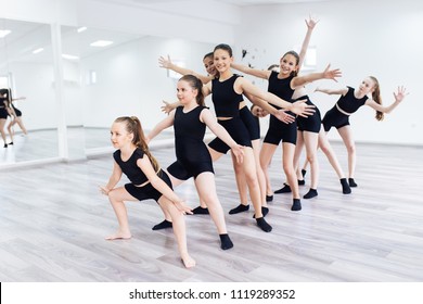 The group of beautiful teenage girls practicing modern ballet dance.