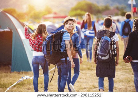 Group of beautiful teens arriving at summer festival
