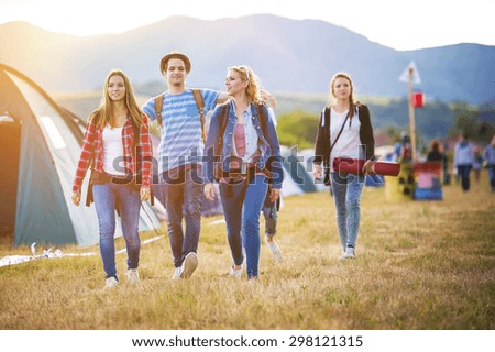 Group of beautiful teens arriving at summer festival
