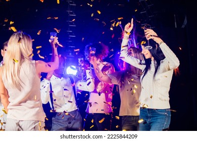 Group of beautiful young people Enjoying party dancing with champagne flutes and looking happy. New year's party - Shutterstock ID 2225844209