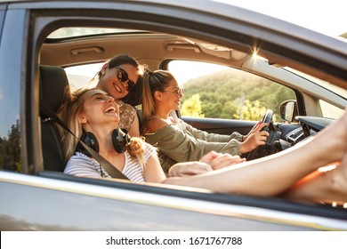 Group Of Best Female Friends Travel Together To Summer Adventure.They Drives A Car And Making Fun.	
