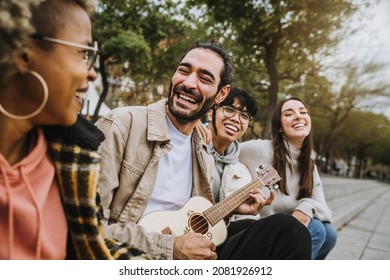 Group Of Best Friends Hanging Out On City Downtown - Happy Guys And Girls Having Fun Together Playing Guitar Outside - Happy Lifestyle And Friendship Concept