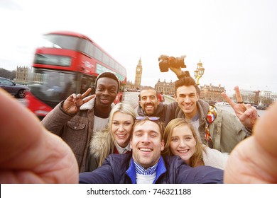 A Group Of Best Friends Have A Lot Of Fun At The Trip In London Making A Selfie For Remember The Funny Time In England. Multiracial Young Hipster People Make Sightseeing And Visit Big Ben Tower.