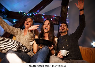 Group best friends sitting at home on pleasant evening and watching a comedy movie .Watching late night show. - Powered by Shutterstock