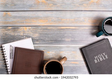 A Group of Bibles for a Study with Hot Coffee on a Distressed Wooden Table