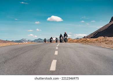 a group of bike riders waving at camera while riding - Powered by Shutterstock