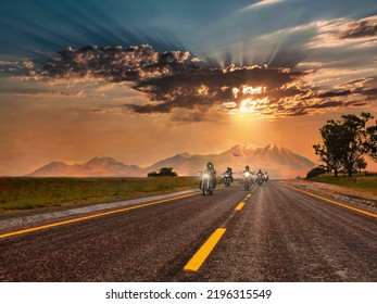 Group of bikers riding on the highway, at sunset, mountains behind, freedom concept          