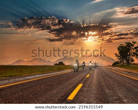 Group of bikers riding on the highway, at sunset, mountains behind, freedom concept          