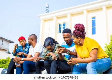 Group Of Black African Friends Addicted By Mobile Smart Phone. Friends Having Fun Outdoor Using Phone