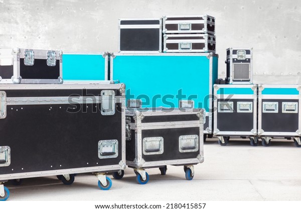 Group\
of black and blue flight cases on a concrete\
floor