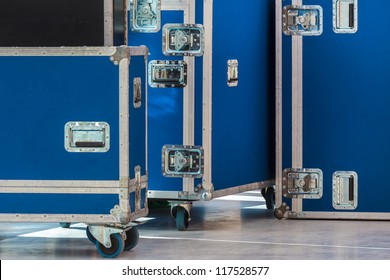 Group of blue flight cases on a grey floor
