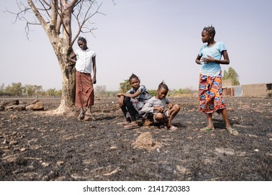 Group Of Bored Young African Girls Aimlessly Hanging Around In The Arid, Desolate Landscape Of Their Home Village; Social Issue Of Demographic Growth, Neglection, Low School Attendance Or High Dropout