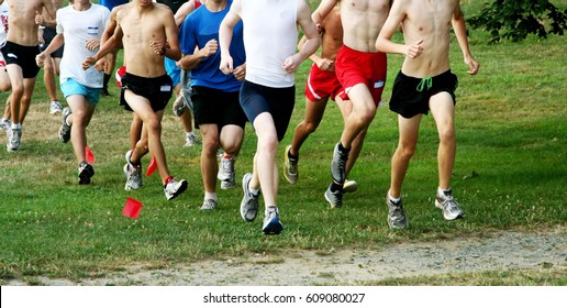 A Group Of Boys Running A Cross Country Race