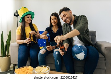 Group Of Brazilian Friends Watching A Football Match On TV