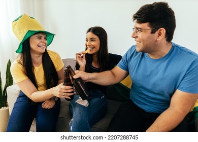 Group Of Brazilian Friends Watching A Football Match On TV