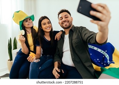 Group Of Brazilian Friends Watching A Football Match On TV