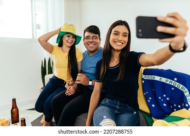 Group Of Brazilian Friends Watching A Football Match On TV