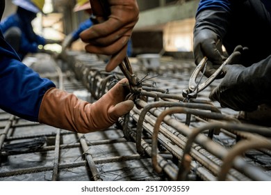 A group of builders is busy constructing a metal structure - Powered by Shutterstock