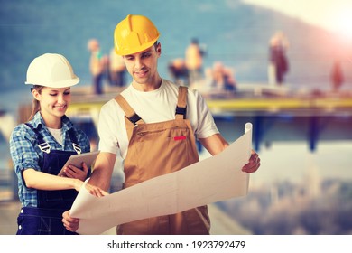 Group Of Builders In Hardhat Works On The Construction Site.