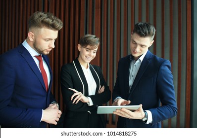 Group Of Buisness People Working On Tablet.