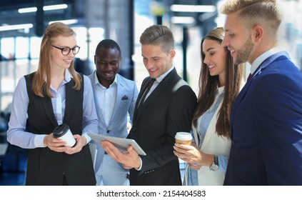 Group Of Buisness People Working On Tablet