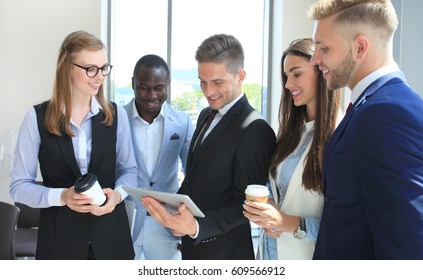 Group Of Buisness People Working On Tablet