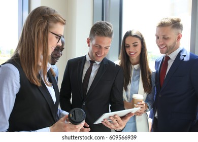 Group Of Buisness People Working On Tablet