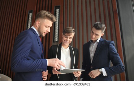 Group Of Buisness People Working On Tablet.