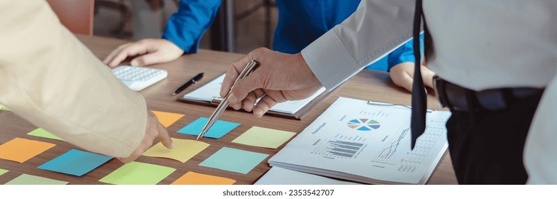 Group of business colleague reads data in sticky notes to discuss and coworking about new business. - Powered by Shutterstock