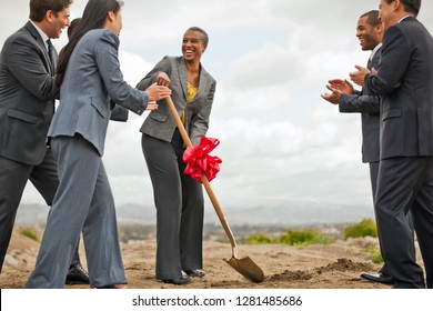 Group Of Business Colleagues Breaking Ground On A Project.