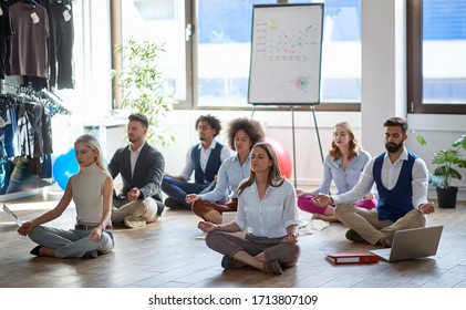 group of business colleagues meditating at work, sitting on the floor. modern, business, meditation concept - Powered by Shutterstock