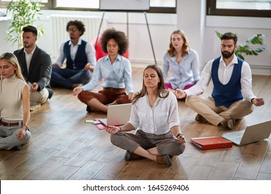 group of business coworkers meditating at work, sitting on the floor. modern, business, meditation  - Powered by Shutterstock