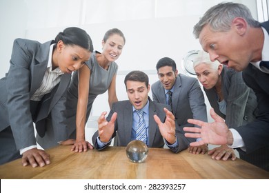 Group Of Business Man Predict The Future With A Crystal Ball