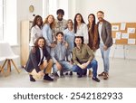 Group of business multiethnic people men and women looking cheerful at camera and smiling indoors. Diverse company employees or group of staff standing in office. Team work concept.