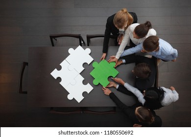 Group Of Business People Assembling Jigsaw Puzzle, Team Support And Help Concept