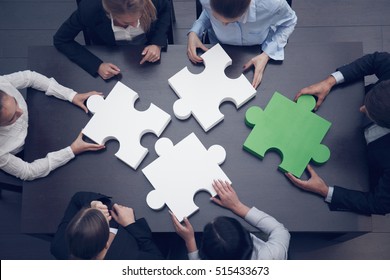 Group Of Business People Assembling Jigsaw Puzzle, Team Support And Help Concept