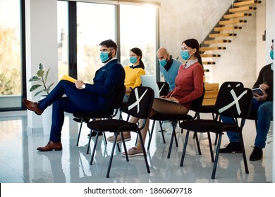 Group Of Business People Attending A Seminar In Board Room And Wearing Face Masks Due To COVID-19 Pandemic.