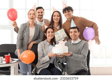 Group of business people with Birthday cake at party in office - Powered by Shutterstock