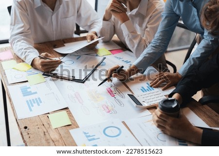 group of business people brainstorm discussing current finance and economy on company investment paperwork at meeting room