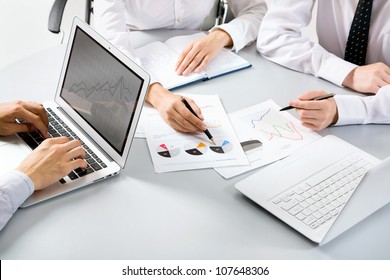 Group Of Business People Busy Discussing Financial Matter During Meeting